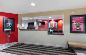 a waiting room with red walls and a mirror at Extended Stay America Suites - Dallas - Greenville Avenue in Dallas