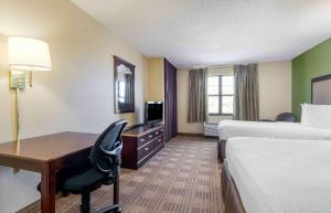 a hotel room with two beds and a desk at Extended Stay America Suites - Dallas - Greenville Avenue in Dallas