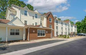 a row of apartment buildings on a street at Extended Stay America Suites - Newport News - Yorktown in Newport News