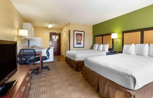 a hotel room with two beds and a desk at Extended Stay America Suites - Fort Worth - City View in Fort Worth