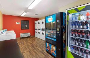 a store aisle with a soda machine in a store at Extended Stay America Suites - Fort Worth - City View in Fort Worth