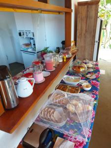 a table with many different types of food on it at Pousada Mirante de Areia-Itaúnas in Itaúnas