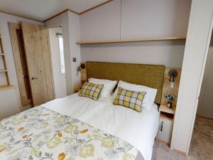a bedroom with a large bed with two pillows at Holiday Home with Stunning Views in Newquay