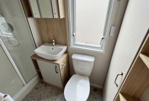 a bathroom with a toilet and a sink and a shower at Holiday Home with Stunning Views in Newquay