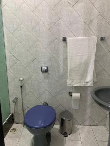 a bathroom with a purple toilet and a sink at Kitnet Penha CEFAN ADVEC in Rio de Janeiro +18 photos
