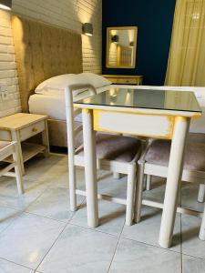 a table and chairs in a room with a bed at Gera Bay Studios And Apartments in Apidias Lakos