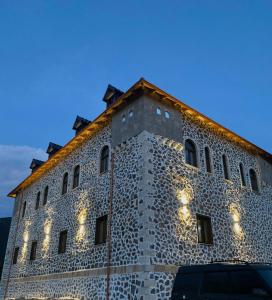 Peshkopi的住宿－Bujtina Oxhaku i Docit，建筑的一侧有灯