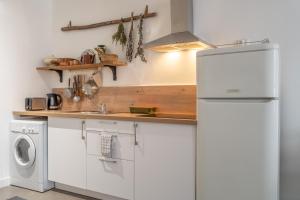 a kitchen with a refrigerator and a washing machine at Appartement Il Sereno - voyage entre les Pouilles et la Sicile in Toulon