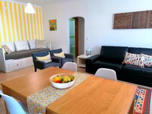 a living room with a bowl of fruit on a table at Apartamento Praiamar in Vila Nova de Milfontes