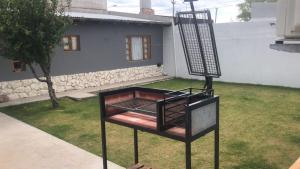 a bird cage sitting on top of a yard at Departamento Luis Vernet in Rawson