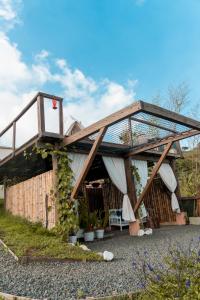 a house with a glass roof and a patio at Glamping La Pau in Cali