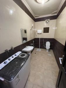 a bathroom with a sink and a toilet at شقة واسعة بفناء خاص و دخول ذاتي in Al Madinah