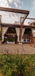 a pavilion with a roof and some plants and flowers at Glamping La Pau in Cali