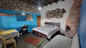 Postel nebo postele na pokoji v ubytování HOTEL RINCÓN MAGICO REAL DE CATORCE