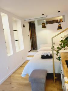 a bedroom with a white bed and two windows at Pokoje 100 m od morza in Dziwnów