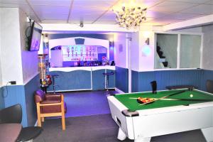 a room with a pool table and a bar at The Merlin Hotel in Blackpool