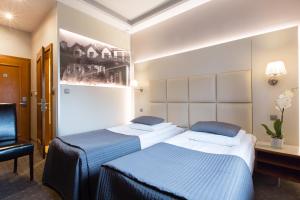 Postel nebo postele na pokoji v ubytování Hotel Galicja Wellness & SPA