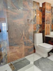 a bathroom with a toilet and a shower at Pokoje 100 m od morza in Dziwnów +43 photos