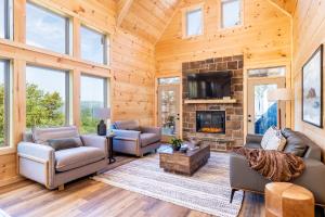 a living room with couches and a fireplace at Cloudchaser Cabin, Private, New Cabin, 2 Kings, Cozy, Modern, Hot Tub, View, Theater in Sevierville