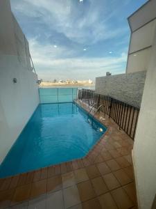 a swimming pool on the roof of a building at سافانا امواج Amwaj savana in Half Moon Bay