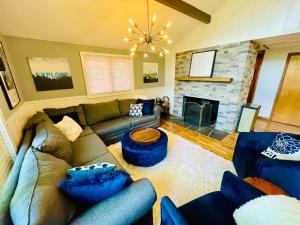 a living room with a couch and a fireplace at Contemporary Magic Mountain Chalet Close to Skiing, Hiking, Fun in Londonderry