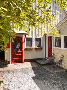 a red door and a table in front of a building at Moonrise on Mill St. Inn- Carriage Haus in Nevada City