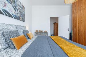a bedroom with a king sized bed with an orange pillow at The place to be in Nice in Nice