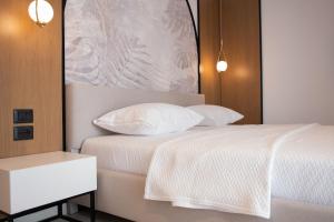Postel nebo postele na pokoji v ubytování Colosseum Hotel