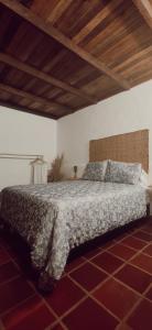 a bedroom with a bed in a room with a wooden ceiling at Glamping La Pau in Cali