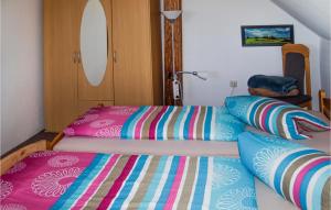 a bedroom with two beds with colorful sheets at Amazing Home In Mirow- Ot Qualzow With Wifi in Qualzow