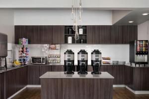 a kitchen with a counter with two water bottles on it at Residence Inn Costa Mesa Newport Beach in Costa Mesa