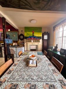 a dining room with a table and a kitchen at Green Dragon LUDLOW in Ludlow