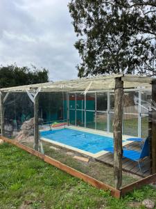 una piscina en una casa de cristal en Casa CALMA en Villa Serrana, en Villa Serrana