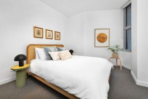 A bed or beds in a room at The View by Experience Jervis Bay