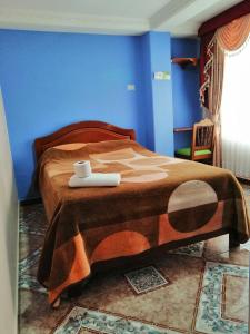 a blue bedroom with a bed with a tray on it at HOTEL LA 7MA AZUL in Pasto