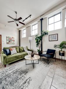 a living room with a green couch and a table at Sleepover 2BD 1BA Downtown Springfield Condos in Springfield