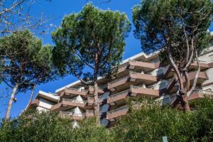 un edificio alto con árboles delante de él en Residence Parco Salario, en Roma