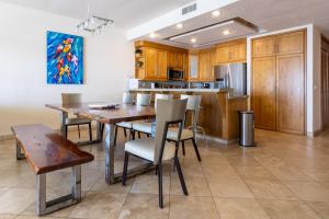 a kitchen with a table and chairs and a dining room at Playa Blanca Condo - 9th Floor Ocean Views! in San Carlos