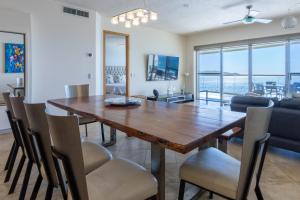 a dining room with a wooden table and chairs at Playa Blanca Condo - 9th Floor Ocean Views! in San Carlos