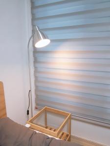a room with a lamp and a window with a bed at Changdong Property in Seoul