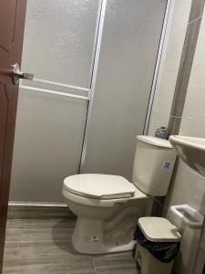 a bathroom with a toilet and a shower at Hotel Amatista-Cerca al Aeropuerto in Bogotá