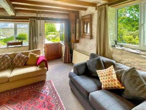 a living room with two couches and a window at Stable Cottage in Leintwardine