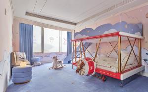 a childs room with a bed with a cloud mural at Four Seasons Hotel Beijing in Beijing