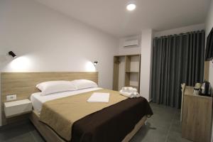 Postel nebo postele na pokoji v ubytování Hotel Villa Adrian