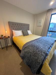 a bedroom with a large bed with a window at Remarkables Retreat Apartment in Queenstown