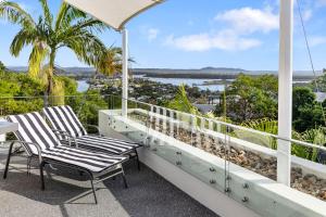 two chairs on a balcony with a view of the ocean at 5 76 Upper Hastings Street in Noosa Heads