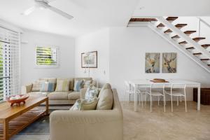 a living room with a couch and a table at 5 76 Upper Hastings Street in Noosa Heads