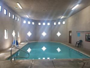 a swimming pool in a building with airus at Americas Best Value Inn Prescott Valley in Prescott Valley