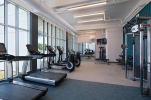 a gym with treadmills and ellipticals in a building at Aloft Austin Southwest in Austin