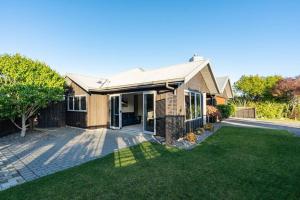 a house with a lawn in front of it at Peaceful on Punawai in Taupo